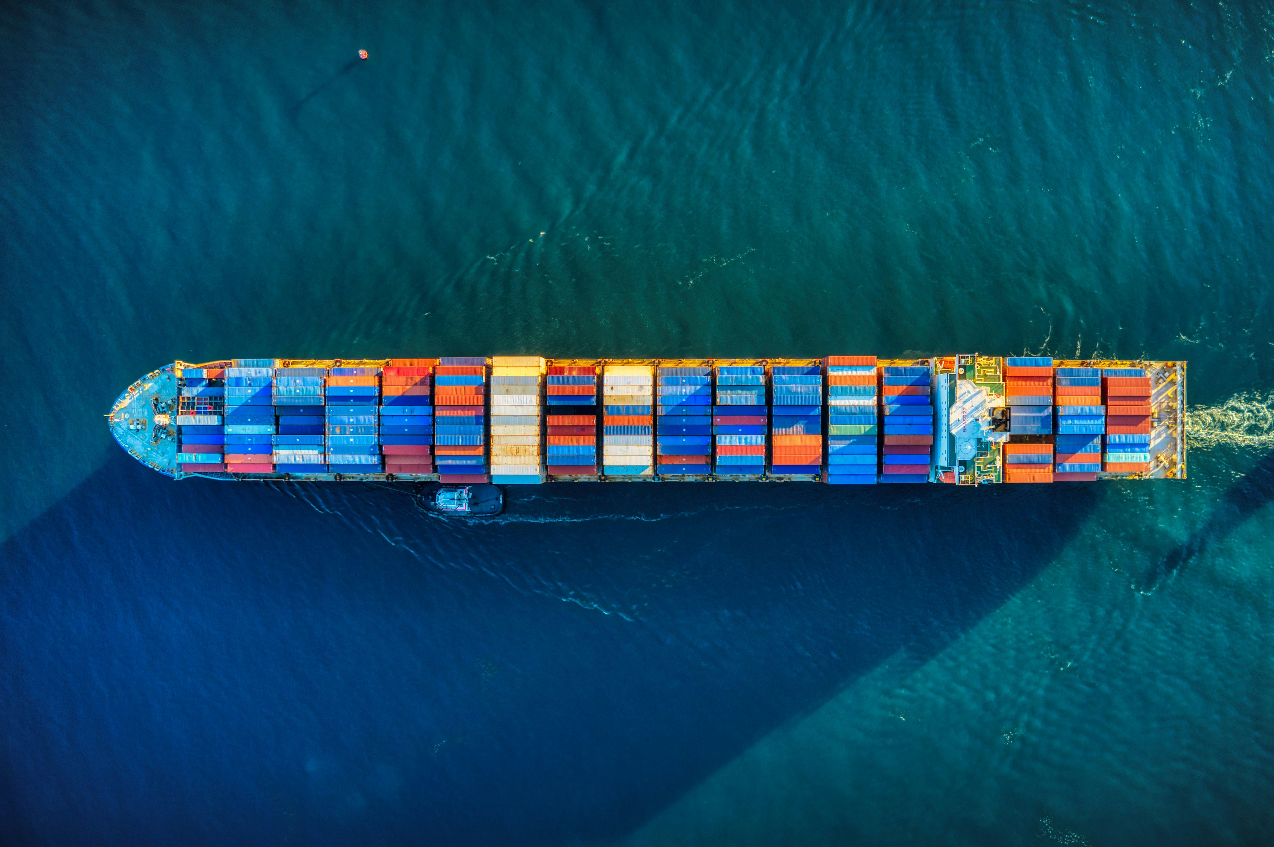 Shipping containers at a port representing the CAPE refund pipeline passing $100 billion